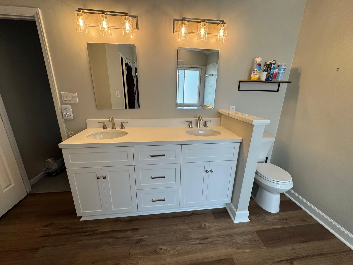 Double vanity with new mirrors and lighting we installed