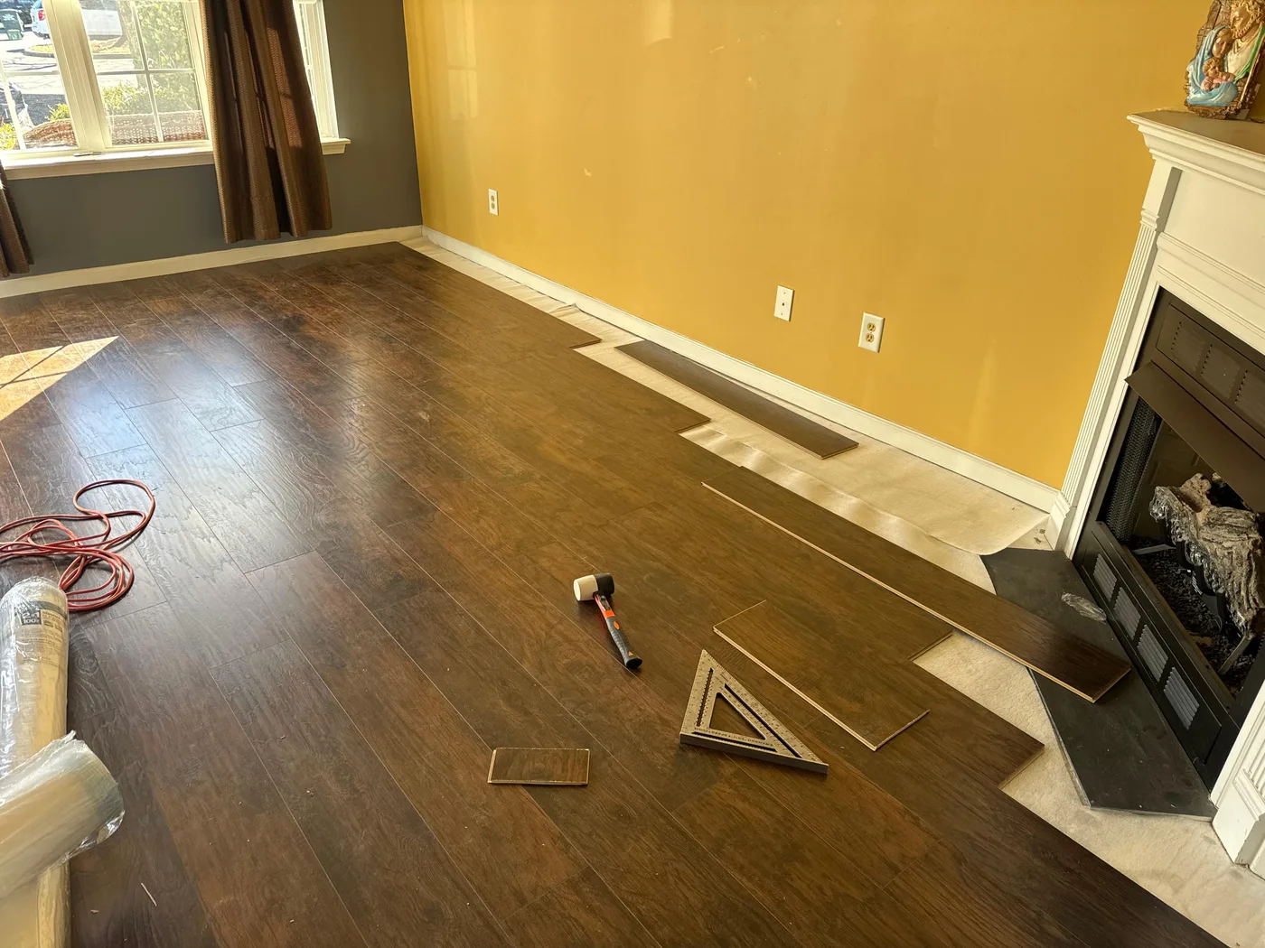 Wood flooring installation in progress in a living room
